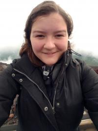 Smiling white woman in dark jacket
